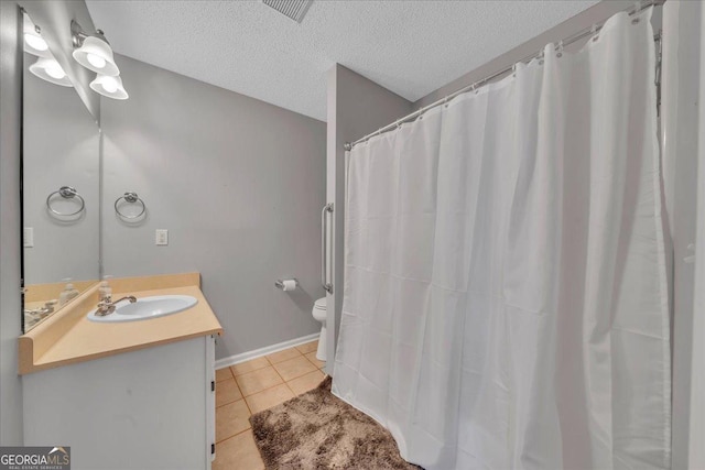 bathroom featuring visible vents, toilet, tile patterned flooring, a textured ceiling, and vanity