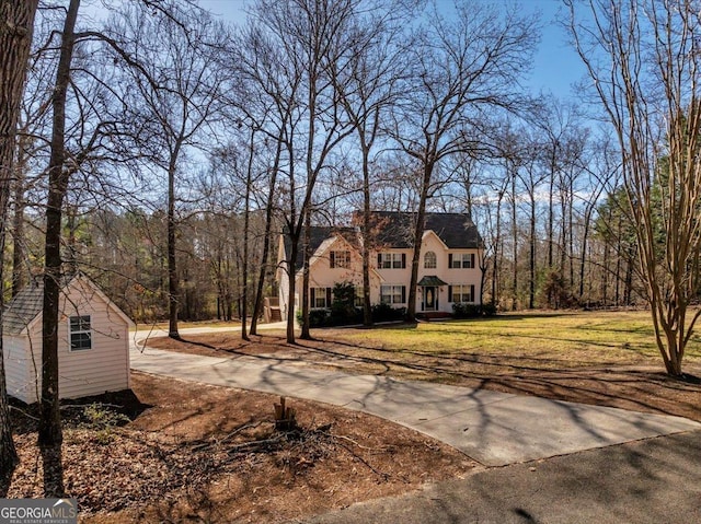 view of front facade featuring a front lawn and a chimney