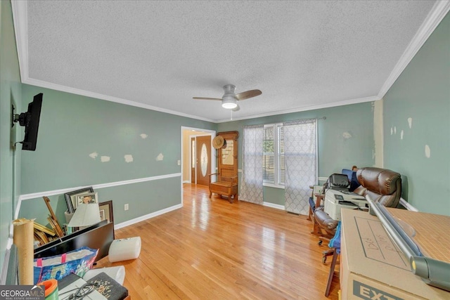 office area featuring a textured ceiling, wood finished floors, a ceiling fan, and crown molding