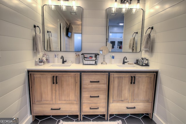 bathroom featuring double vanity, tile patterned flooring, and a sink