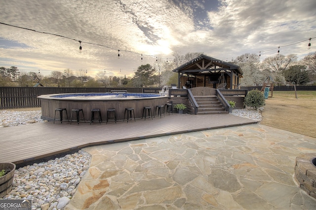 view of patio featuring fence, a fenced in pool, and a wooden deck