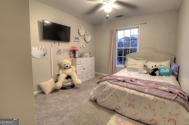 carpeted bedroom with a ceiling fan, visible vents, and baseboards