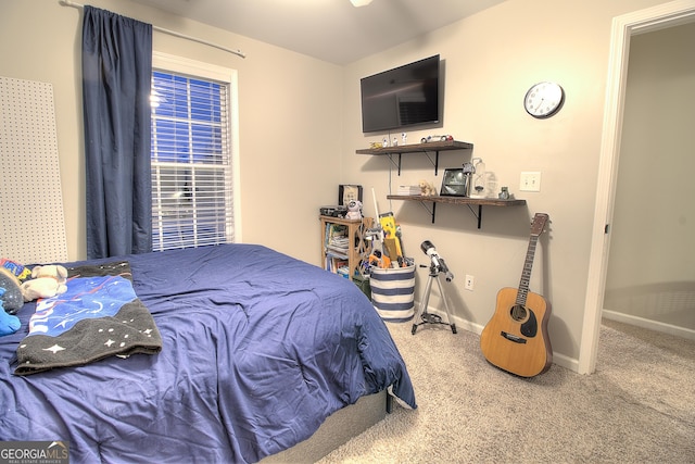 bedroom featuring carpet floors and baseboards