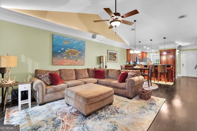 living room featuring dark wood-style floors, visible vents, ornamental molding, vaulted ceiling, and ceiling fan with notable chandelier