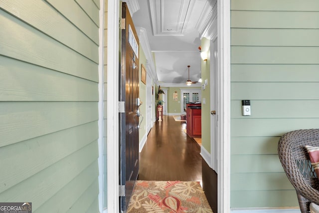 hallway featuring baseboards and dark wood-type flooring