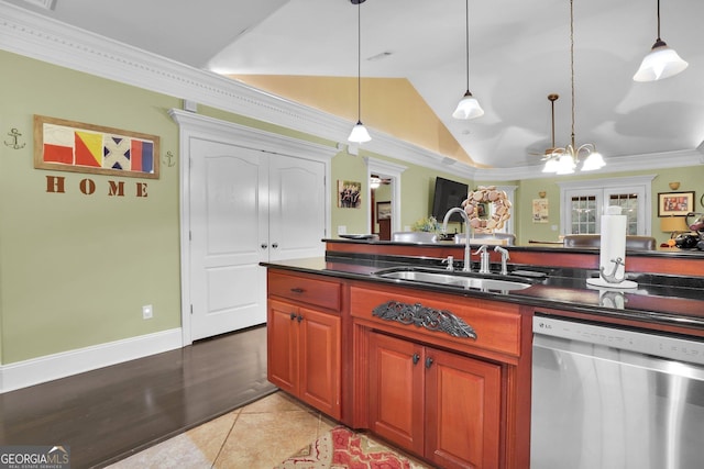 kitchen with dishwasher, vaulted ceiling, dark countertops, and a sink