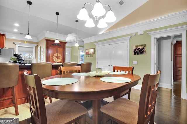 dining space with crown molding, visible vents, vaulted ceiling, and dark wood-type flooring