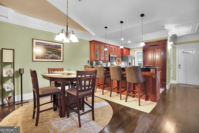 dining space featuring lofted ceiling, dark wood-type flooring, baseboards, and crown molding