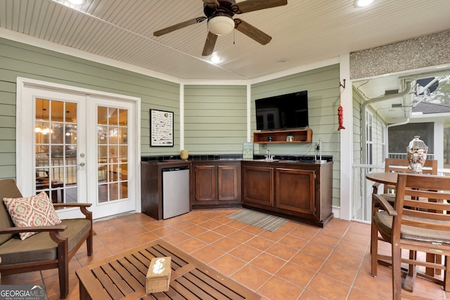 kitchen featuring refrigerator, french doors, light tile patterned flooring, and dark countertops