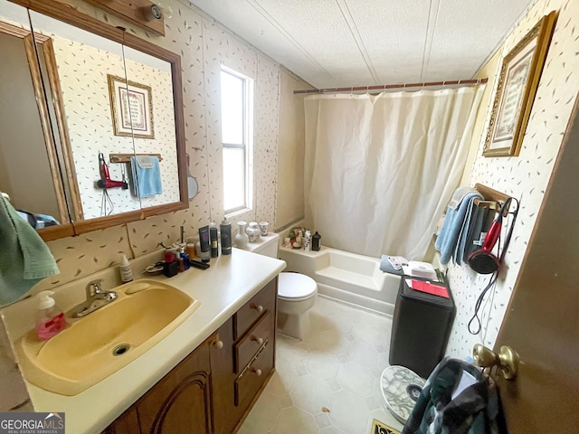 bathroom featuring a textured ceiling, toilet, and wallpapered walls