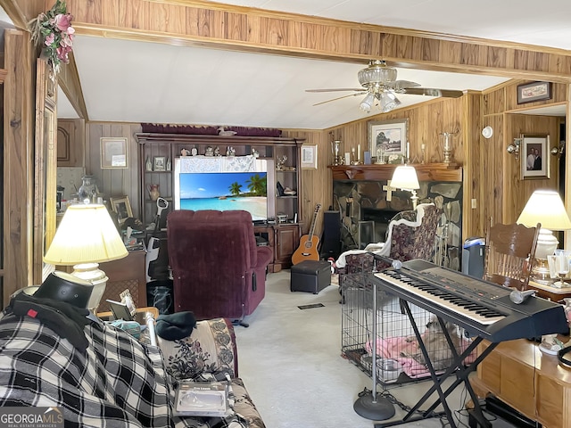 carpeted living area featuring a ceiling fan, lofted ceiling, a fireplace, and wood walls