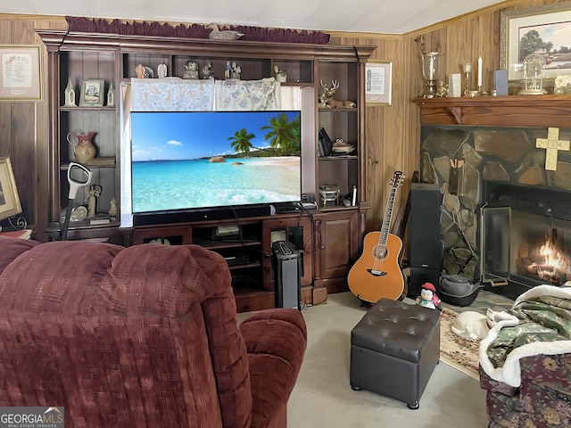 living area with carpet, wood walls, and a fireplace