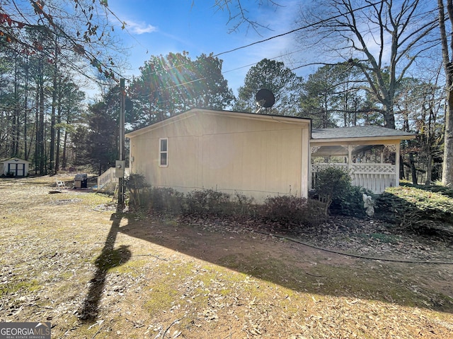 view of property exterior featuring a storage unit and an outdoor structure