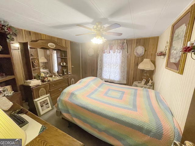 bedroom with wood walls and ceiling fan