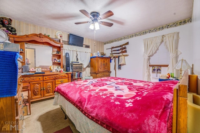 bedroom with light colored carpet, a textured ceiling, and wallpapered walls