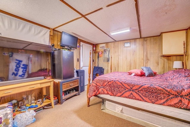 bedroom featuring a textured ceiling, wood walls, and carpet