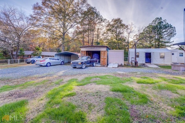 view of parking with a carport and driveway