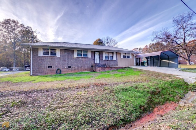 ranch-style house featuring crawl space, fence, a front lawn, and a detached carport