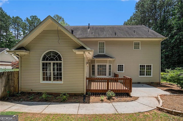 back of house featuring crawl space, fence, and a wooden deck