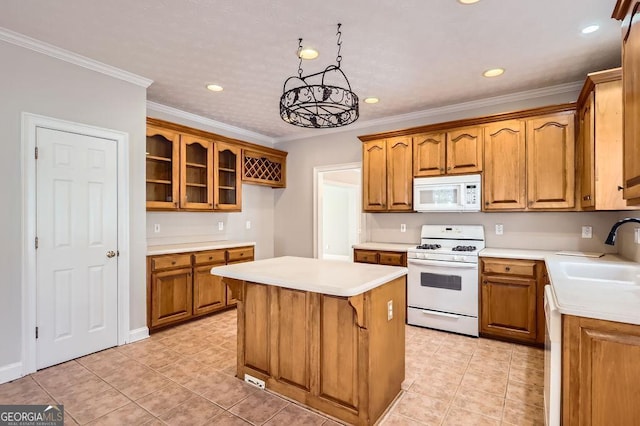 kitchen featuring white appliances, brown cabinetry, a sink, and light countertops