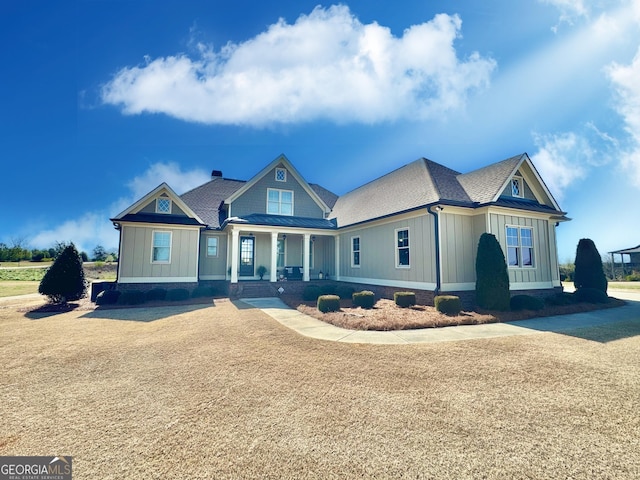 view of front of home with a standing seam roof, a shingled roof, and board and batten siding