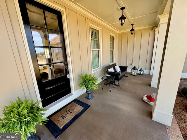 entrance to property featuring a porch and board and batten siding