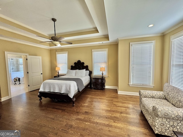 bedroom with a tray ceiling, ornamental molding, a ceiling fan, wood finished floors, and baseboards