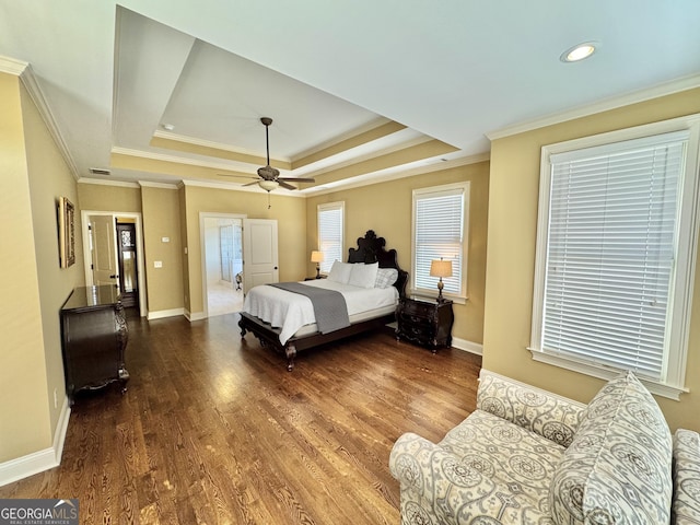 bedroom featuring crown molding, baseboards, a raised ceiling, and wood finished floors