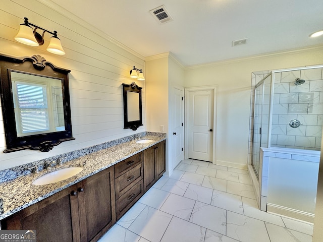 full bathroom with visible vents, marble finish floor, crown molding, a shower stall, and a sink