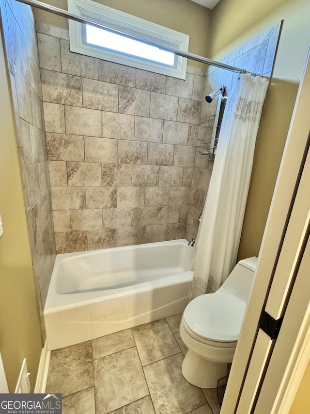 bathroom featuring shower / bath combination with curtain and toilet