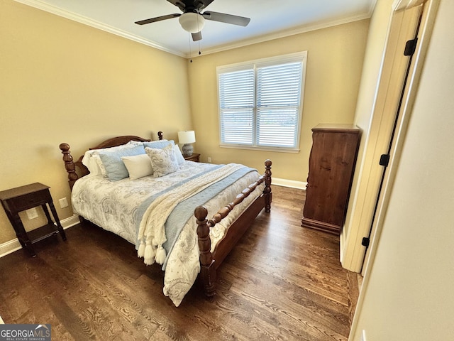 bedroom featuring dark wood-style floors, crown molding, and baseboards