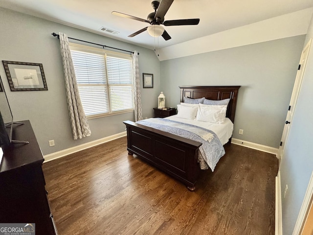 bedroom featuring dark wood-style floors, visible vents, and baseboards