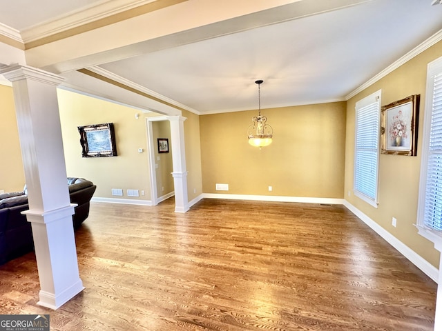 interior space with ornate columns, crown molding, and light wood-style floors