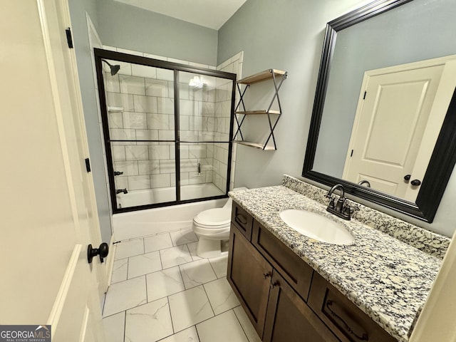 full bath featuring marble finish floor, combined bath / shower with glass door, vanity, and toilet