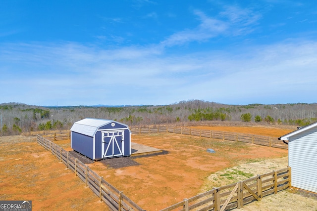 view of shed featuring fence and a rural view