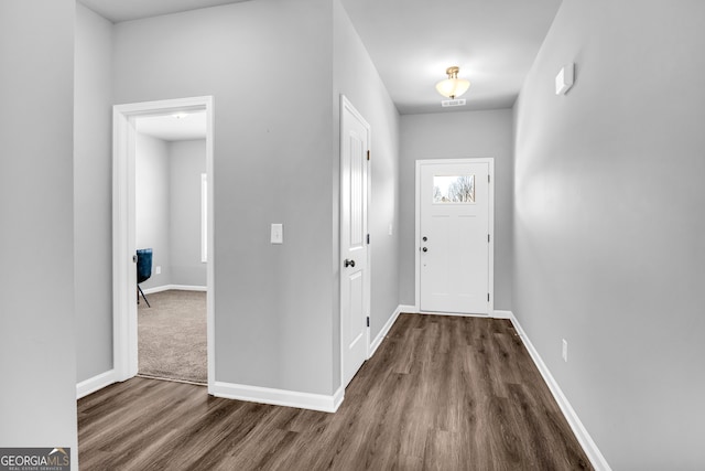 foyer featuring wood finished floors, visible vents, and baseboards