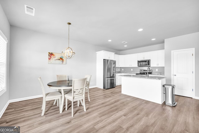 kitchen featuring recessed lighting, visible vents, white cabinets, appliances with stainless steel finishes, and light wood finished floors