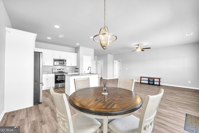 dining space featuring light wood-style floors, visible vents, and recessed lighting