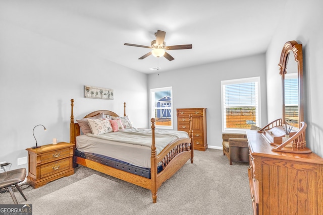 bedroom featuring light carpet, ceiling fan, and baseboards