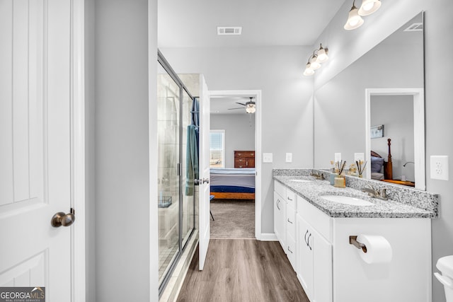 ensuite bathroom with a sink, connected bathroom, and visible vents