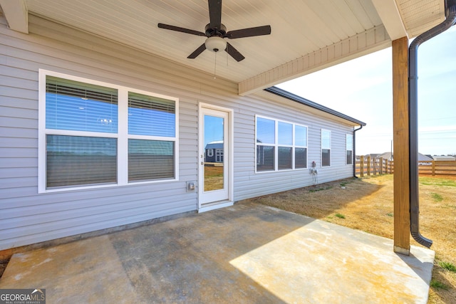 view of patio with ceiling fan and fence