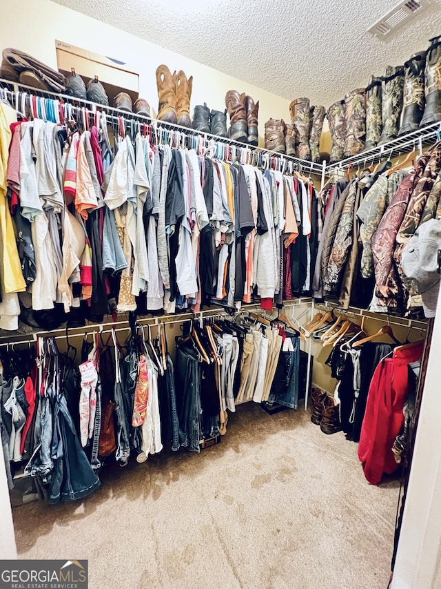 walk in closet featuring carpet flooring and visible vents