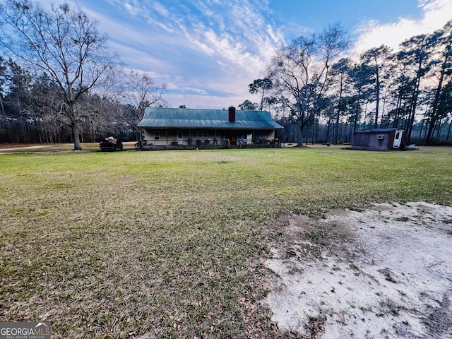 view of yard featuring a storage shed and an outbuilding