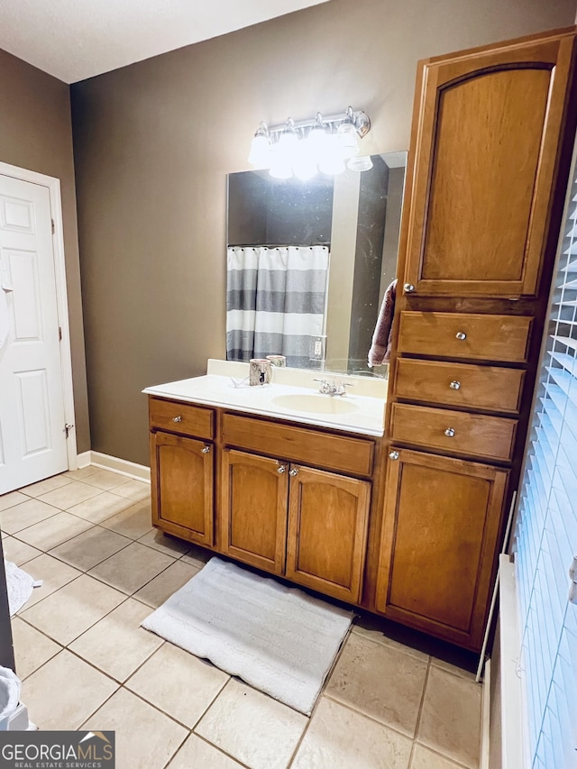 bathroom with baseboards, a shower with shower curtain, vanity, and tile patterned floors