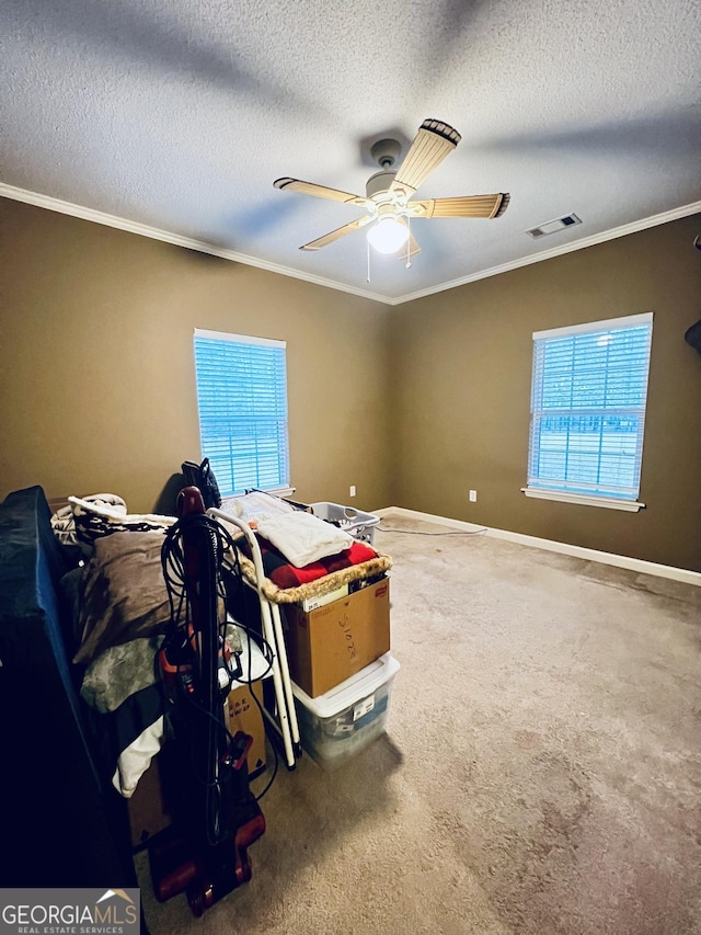 carpeted bedroom with baseboards, multiple windows, ornamental molding, and a textured ceiling