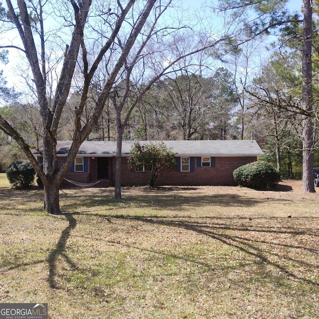 single story home with brick siding and a front lawn