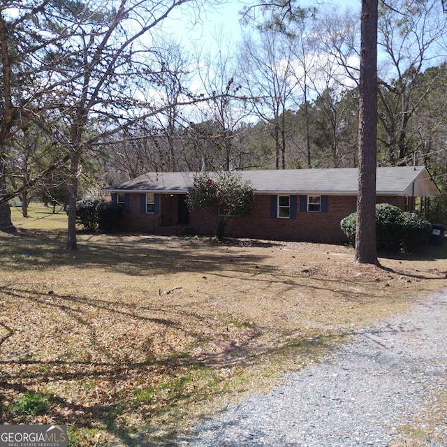 single story home featuring brick siding