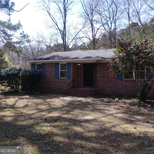 ranch-style home featuring brick siding