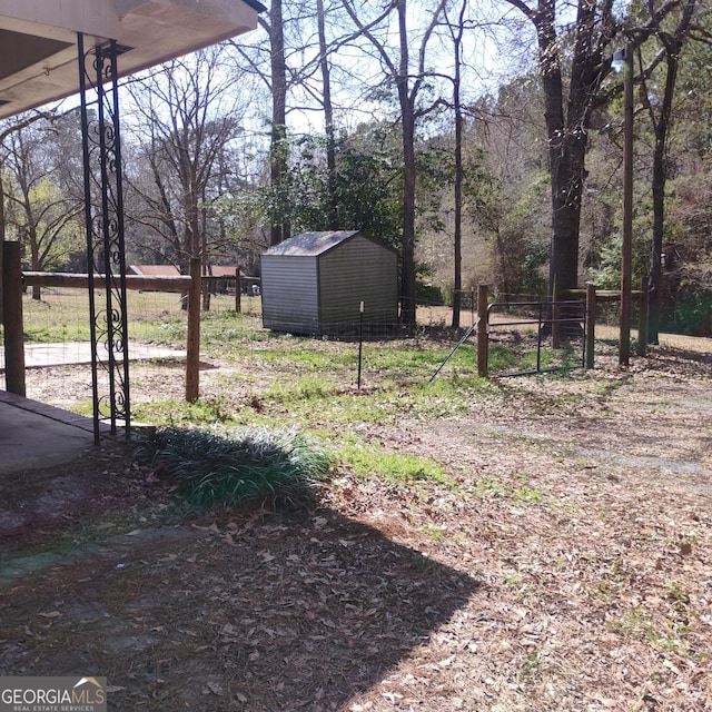 view of yard with a storage unit, an outdoor structure, and fence