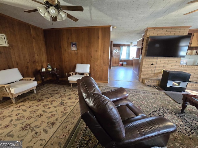 living room with ceiling fan and wooden walls